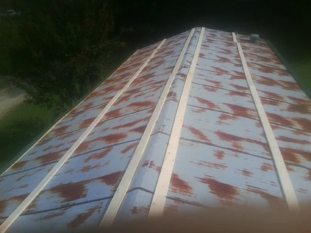 Rusted metal roof panels with new wood purlins before replacement — Storm Damage Roof Repair in Pierceton by Roofing Brothers