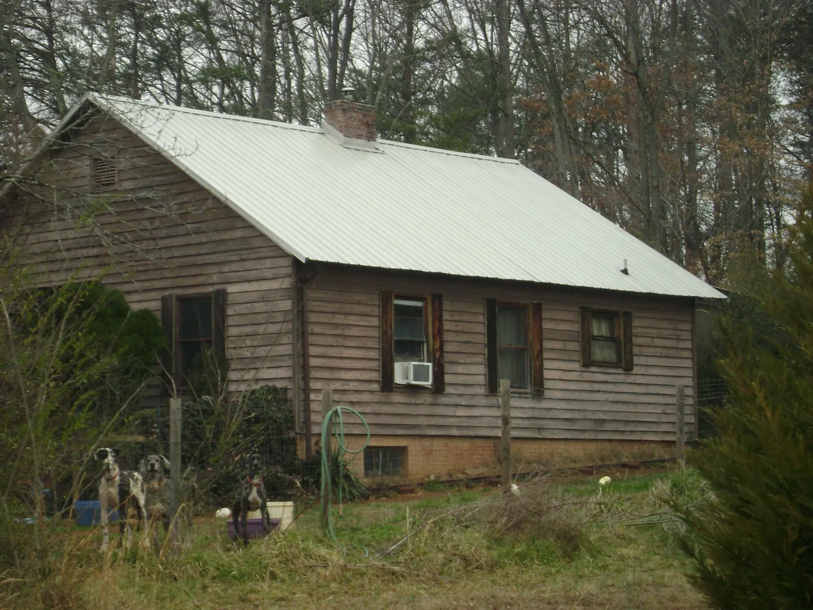White metal roof on an old wood sided farmhouse, from a Metal Roof Installation job in Pierceton